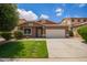 Inviting single-story home showcases a vibrant lawn, desert landscaping, and classic Southwestern architecture with a tile roof at 45309 W Gavilan Dr, Maricopa, AZ 85139