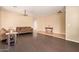 Spacious living room with dark hardwood floors and neutral walls, seamlessly blending into tiled entryway for a harmonious design at 45309 W Gavilan Dr, Maricopa, AZ 85139