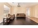 Cozy living room features a plush brown sofa, dark hardwood floors, and neutral paint at 45309 W Gavilan Dr, Maricopa, AZ 85139