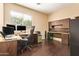 Bright office space with desk, cabinets and hardwood floors at 45309 W Gavilan Dr, Maricopa, AZ 85139