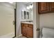 Bathroom features a single vanity with a granite countertop, glass door shower, and white toilet at 5350 E Deer Valley Dr # 1433, Phoenix, AZ 85054