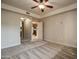 Bedroom with neutral carpet, ceiling fan, and view into the kitchen through an arched doorway at 5350 E Deer Valley Dr # 1433, Phoenix, AZ 85054