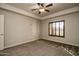 Bedroom with neutral carpet, window with plantation shutters, and modern ceiling fan at 5350 E Deer Valley Dr # 1433, Phoenix, AZ 85054