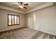 Inviting bedroom features neutral carpet, plantation shutters and a modern ceiling fan at 5350 E Deer Valley Dr # 1433, Phoenix, AZ 85054