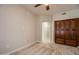 Spacious bedroom with a closet, neutral carpet, and view through an arched doorway at 5350 E Deer Valley Dr # 1433, Phoenix, AZ 85054