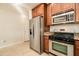 Bright kitchen featuring stainless steel appliances, granite countertops, and tiled flooring at 5350 E Deer Valley Dr # 1433, Phoenix, AZ 85054