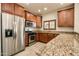 Well-lit kitchen with granite countertops, stainless steel appliances, and wood cabinets at 5350 E Deer Valley Dr # 1433, Phoenix, AZ 85054