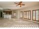Living room with tile floors, ceiling fan and views to the open kitchen with granite counter at 5350 E Deer Valley Dr # 1433, Phoenix, AZ 85054