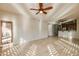 Living area with tiled floor, ceiling fan, and kitchen view through a connecting doorway at 5350 E Deer Valley Dr # 1433, Phoenix, AZ 85054