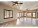 Spacious living room featuring many windows with wooden shutters and tile flooring at 5350 E Deer Valley Dr # 1433, Phoenix, AZ 85054