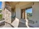 Covered patio with stone pillars and a large window offering serene views and outdoor seating area at 5350 E Deer Valley Dr # 1433, Phoenix, AZ 85054