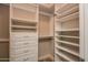 Walk-in closet with built-in shelving, drawers, and hanging rods for organized storage at 5350 E Deer Valley Dr # 1433, Phoenix, AZ 85054