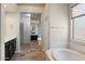 Bright bathroom featuring a large tub, closet with mirror doors and white cabinetry at 6438 E Claire Dr, Scottsdale, AZ 85254