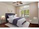 Cozy bedroom with a tufted headboard, large window, and stylish decor at 6438 E Claire Dr, Scottsdale, AZ 85254