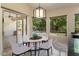 Bright dining area adjacent to kitchen with sliding door access to a covered patio and pool views at 6438 E Claire Dr, Scottsdale, AZ 85254