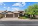 Inviting single-story home with a three-car garage and desert landscaping, offering curb appeal and functionality at 6438 E Claire Dr, Scottsdale, AZ 85254