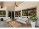 Cozy outdoor patio featuring comfortable seating, a ceiling fan, and sliding glass doors at 6438 E Claire Dr, Scottsdale, AZ 85254