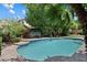 Backyard swimming pool with a hot tub and lush tropical foliage at 6438 E Claire Dr, Scottsdale, AZ 85254