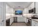 Modern kitchen featuring white cabinets, marble countertops and stainless appliances at 7500 E Deer Valley Rd # 157, Scottsdale, AZ 85255