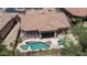 Aerial view of property showing the pool, patio, lush landscaping, and surrounding homes at 7841 E Stonecliff Cir, Mesa, AZ 85207
