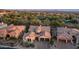 Aerial view of the house, nestled amongst mature trees and lush desert landscaping at 7841 E Stonecliff Cir, Mesa, AZ 85207
