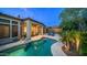 Backyard with pool, patio seating, mature landscaping, and privacy walls at 7841 E Stonecliff Cir, Mesa, AZ 85207