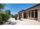 Backyard view of pool, covered patio, and lush landscaping of the home at 7841 E Stonecliff Cir, Mesa, AZ 85207