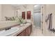 Bathroom with double sinks, tiled counters, and decorative wood cabinetry at 7841 E Stonecliff Cir, Mesa, AZ 85207