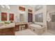 Luxurious bathroom boasts a soaking tub, tiled vanity, and stylish fixtures at 7841 E Stonecliff Cir, Mesa, AZ 85207