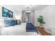 Comfortable bedroom featuring a large bed, blue accents, and modern decor at 7841 E Stonecliff Cir, Mesa, AZ 85207