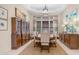 Elegant dining room with a wooden table, chandelier lighting, and a large china cabinet at 7841 E Stonecliff Cir, Mesa, AZ 85207