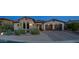 Charming home with a well-manicured front yard and a two-car garage with lovely desert landscaping at 7841 E Stonecliff Cir, Mesa, AZ 85207