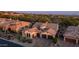 Stunning home with a clay tile roof, beautiful landscaping, and charming curb appeal at sunset at 7841 E Stonecliff Cir, Mesa, AZ 85207