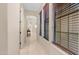 Bright hallway featuring tile flooring, natural light, and neutral paint at 7841 E Stonecliff Cir, Mesa, AZ 85207