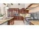 Spacious kitchen features stainless steel appliances, granite counters, tiled flooring, and abundant cabinet space at 7841 E Stonecliff Cir, Mesa, AZ 85207