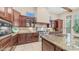 Gourmet kitchen featuring custom cabinets, stainless steel appliances, granite countertops, and a center island at 7841 E Stonecliff Cir, Mesa, AZ 85207
