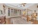 Main bedroom suite with wood floors, beam ceilings, large windows, and sitting area at 7841 E Stonecliff Cir, Mesa, AZ 85207