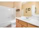Well-lit bathroom featuring a combined shower and tub, vanity with a sink, and neutral color palette at 8874 W Piute Ave, Peoria, AZ 85382