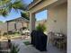 Covered backyard patio with dining set and grill with desert landscaping and privacy walls at 8927 W Paradise Dr, Peoria, AZ 85345