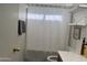 Clean bathroom featuring floating shelves, towel rack, and a shower with curtain at 8927 W Paradise Dr, Peoria, AZ 85345