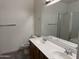Bathroom with double sink vanity, toilet, shower, and neutral tile floors at 8927 W Paradise Dr, Peoria, AZ 85345