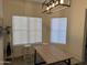 Dining room featuring a modern light fixture and a wood table with bench seating at 8927 W Paradise Dr, Peoria, AZ 85345