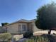 Well-maintained home with desert landscaping, mature trees, and a two-car garage with a charming tile roof at 8927 W Paradise Dr, Peoria, AZ 85345