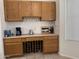 Kitchen area with wine storage, wood cabinets, and a serving counter at 8927 W Paradise Dr, Peoria, AZ 85345