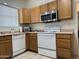 Kitchen featuring white appliances and wood cabinets with light countertops at 8927 W Paradise Dr, Peoria, AZ 85345