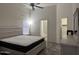Main bedroom with ceiling fan, tile floors, large bed, and access to the bathroom and closet at 8927 W Paradise Dr, Peoria, AZ 85345