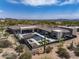 Birds-eye view of modern property with a desert landscape, patio area, and pool at 9456 E Sands Dr, Scottsdale, AZ 85255