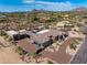 Elevated aerial view of an estate property with garages, and desert landscaping at 9456 E Sands Dr, Scottsdale, AZ 85255