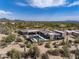 Wide aerial shot of a modern property featuring a pool and mature desert landscaping at 9456 E Sands Dr, Scottsdale, AZ 85255