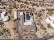 Aerial view of an estate showcasing an expansive desert lot, pool, and unique architecture at 9456 E Sands Dr, Scottsdale, AZ 85255
